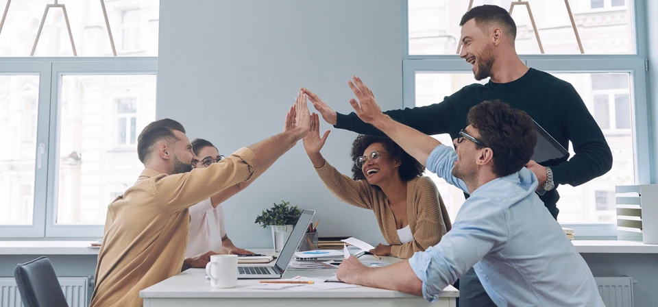 Personne utilisant un ordinateur portable dans un environnement de bureau moderne, mains positionn&eacute;es sur le clavier